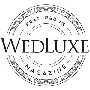 Official seal stating 'FEATURED IN WEDLUXE MAGAZINE' with an intricate circular design, symbolizing prestige in wedding industry recognition.